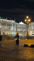 Street musician performs guitar set in St. Petersburg courtyard