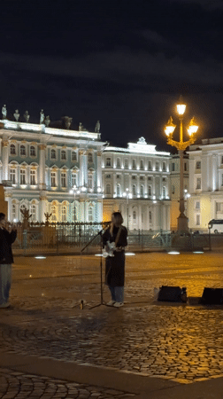 Street musician performs guitar set in St. Petersburg courtyard