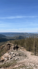 Two hikers pause at cliff overlook near Krasnoyarsk