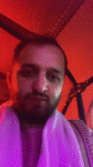 Nighttime auto-rickshaw ride captured in neon-lit Kandahar streets