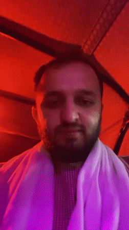 Nighttime auto-rickshaw ride captured in neon-lit Kandahar streets