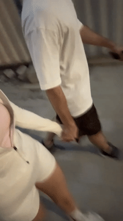 Couple walks hand-in-hand through Dubai streets