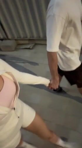 Couple walks hand-in-hand through Dubai streets
