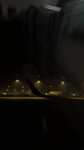 Passenger documents nighttime aircraft operations at Shanghai Pudong Airport