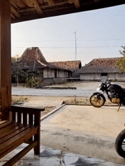 Quiet morning in a rural Wirosari neighborhood, motorcycles and traditional houses