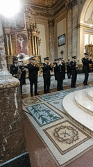 Military band performs in ornate church early morning