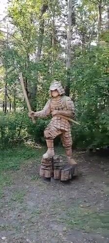 Svirsk park with wooden samurai sculpture and modern pavilions