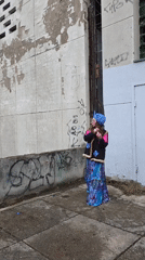Street fashion photoshoot captured against urban graffiti wall