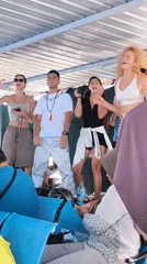 Young adults dance together at Indonesian ferry terminal
