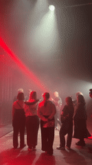 Small gathering in foggy Moscow venue with stage lighting