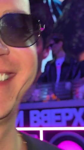 Nightclub patrons film selfies during performance in Druzhba, Russia