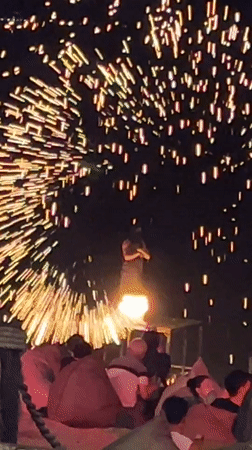 Fire dancer performs with fireworks show in Baan Bo Phut