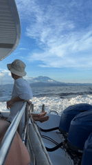 Passenger watches horizon from boat stern in Indonesian waters