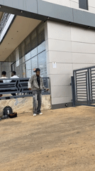 Street dancer performs outside modern building in Bukuru, Nigeria
