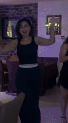 Woman sings and dances at restaurant dinner party