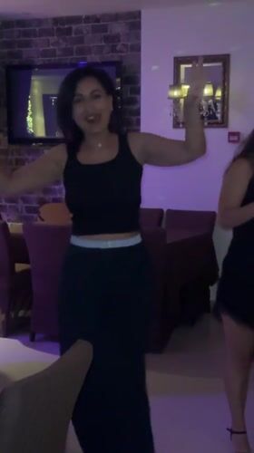 Woman sings and dances at restaurant dinner party