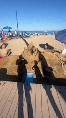 Busy beach day documented across Barcelona waterfront during afternoon hours