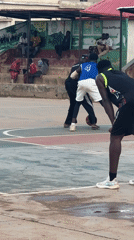 Pickup basketball on a worn outdoor court in Jos, Nigeria