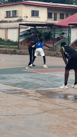 Pickup basketball on a worn outdoor court in Jos, Nigeria