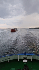 Cargo ships navigate choppy waters near Novokemskii, Russia