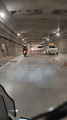 Riding through a wet, lit tunnel in Burwa, India