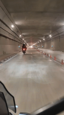 Riding through a wet, lit tunnel in Burwa, India