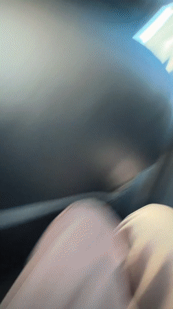 Woman in car passenger seat touches forehead in Russia