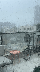 Heavy rain obscures city views from Tel Aviv balcony