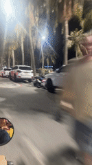 Motorcyclist rides through nighttime Pattaya streets amid traffic
