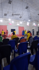 Dance crew performs on decorated stage in colorful athletic wear