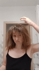 Woman dries hair in Yekaterinburg bathroom