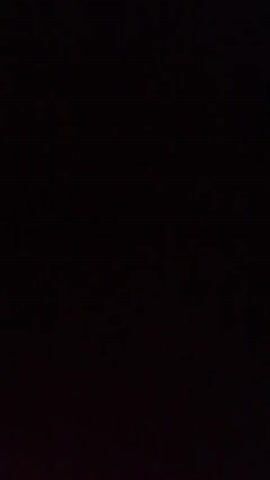 The video shows a very dark room. A wooden wardrobe is visible in the first and second frames. In the third frame, a dark door with a window is visible, with a textured wall above it. The remaining frames are completely black.