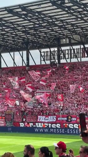Red and white soccer fans pack Essen stadium stands