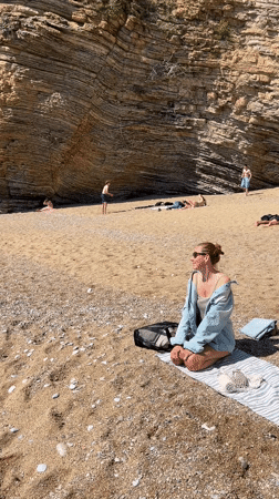 Beachgoers gather on sandy shores in Budva, Montenegro