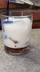 Layered blue and red iced drink being built step by step