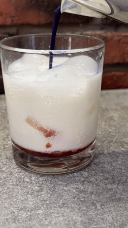 Layered blue and red iced drink being built step by step
