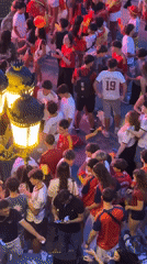 Crowds in Spanish colors celebrate outdoors in Las Rozas de Madrid