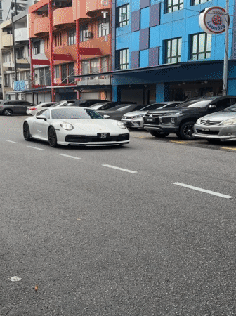 White Porsche spotted driving near veterinary clinic in Malaysia