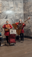Street musicians perform indoors in Moscow wearing matching outfits