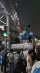 Workers load cargo onto trucks across Dhaka locations