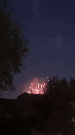 Evening scenes and fireworks in Blagoveshchensk with illuminated bridge