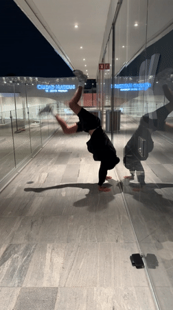 Man performs late-night handstand exercise in Puebla, Mexico