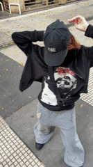 Person walks two dogs on Buenos Aires sidewalk