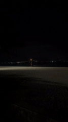 Nighttime waves reach illuminated Guan Yin statue in Đà Nẵng
