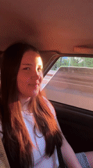 Young women share playful moments during car ride in Perm