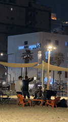 Evening beach gathering with wine near Tel Aviv hostel