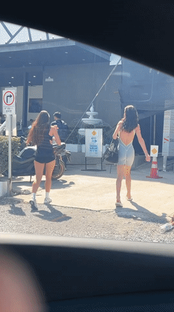 Two women walk past Legacy Shop in Choeng Mon