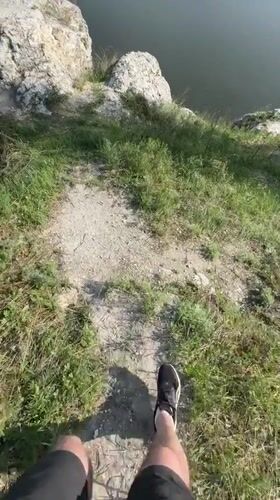 Hiker reaches cliff overlook near Serga, Russia