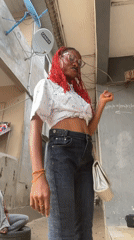 Fashion shoot featuring red-haired woman in Badagry alleyways
