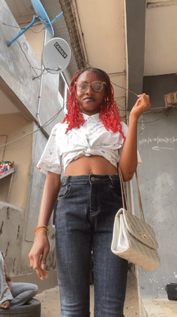 Fashion shoot featuring red-haired woman in Badagry alleyways